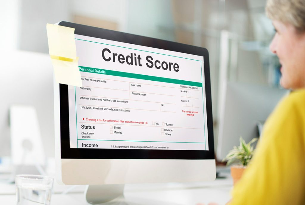Older woman looking at her computer screen, which shows a credit score